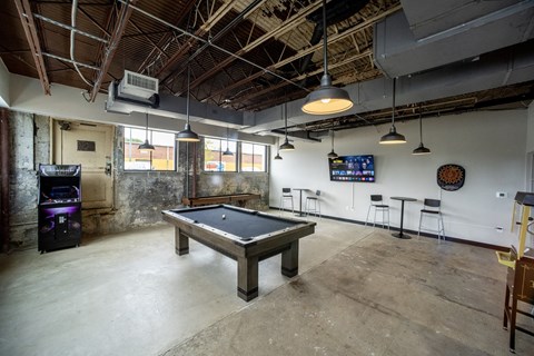 a pool table sits in the middle of a room with a tv in the background at Conwood Flats, Memphis, Tennessee